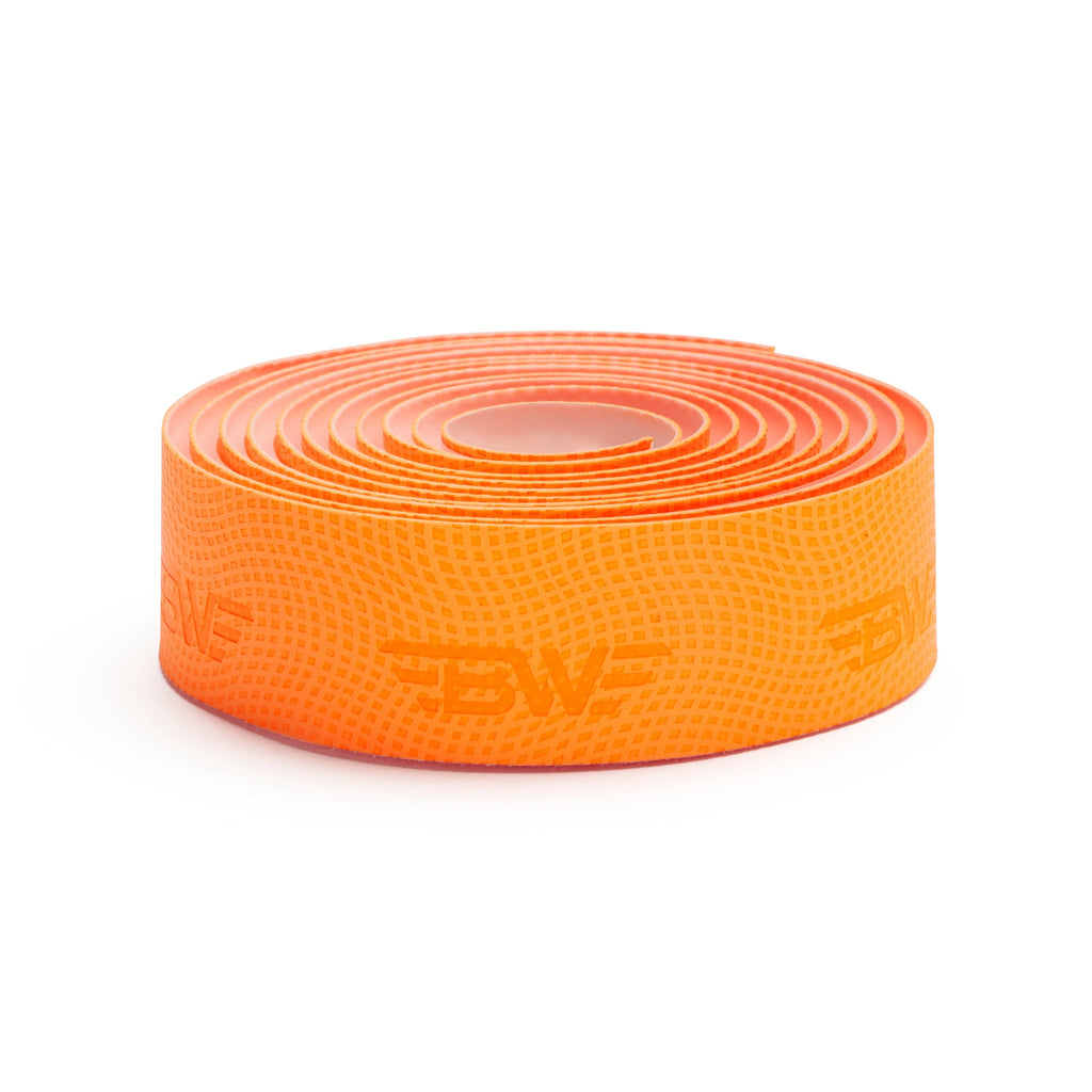 roll of orange PU handlebar tape on its side. High quality polyurethane orange handlebar tape.